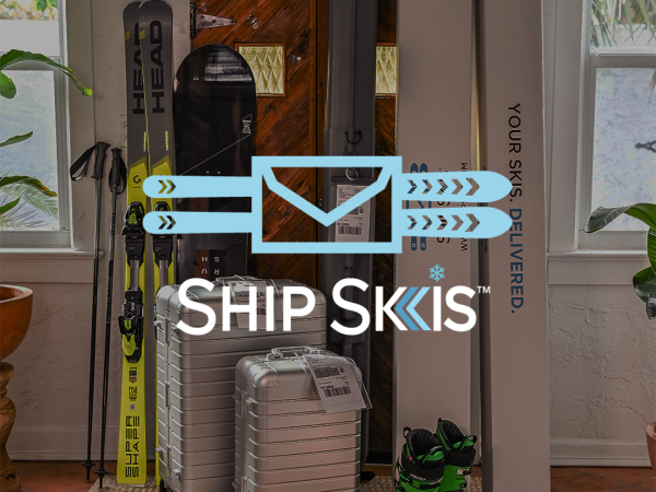 The image shows skis, ski boots, a suitcase, and a 